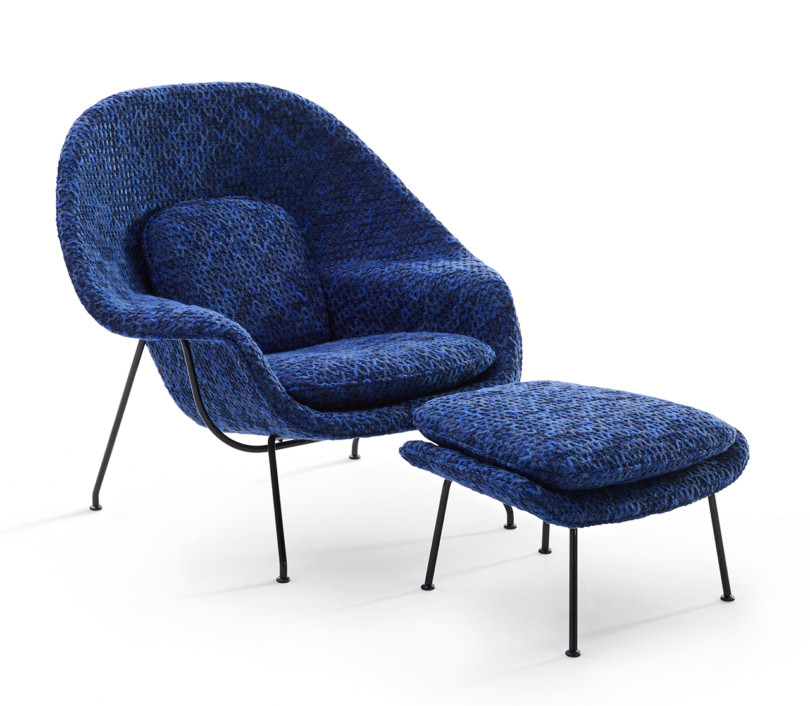 dark blue armchair with matching ottoman on white background