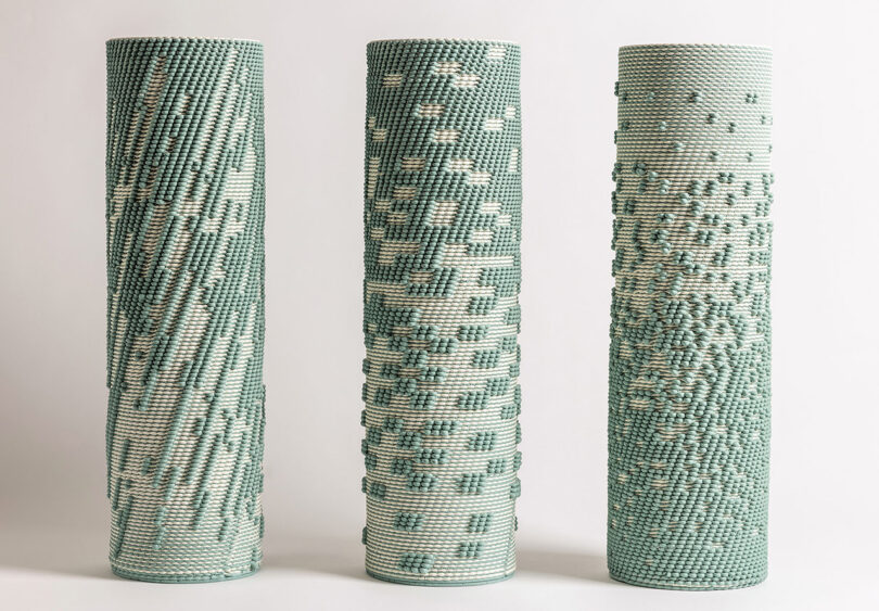 Three green and natural clay hued Dyadic Series dual extrusion 3D printed ceramic sculptures, showcasing their woven-like patterns and textures created by 3D printing with two clay colors simultaneously. 