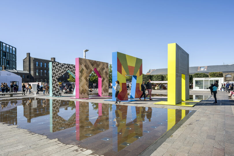 four colorful facades with an opening in the middle of each for people to interact