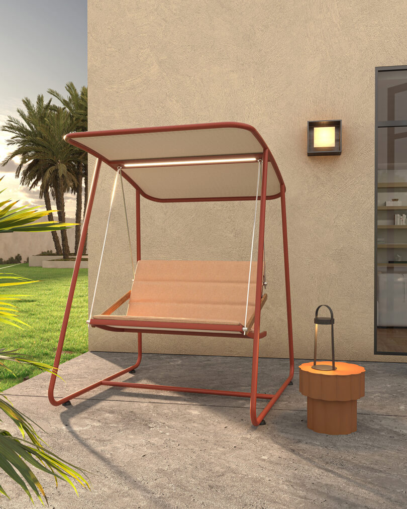 steel framed covered outdoor swing with cushion on a patio