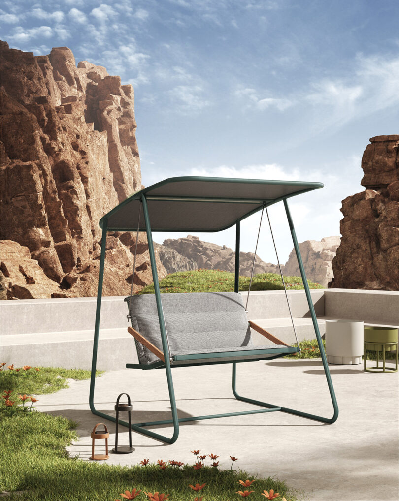 steel framed covered outdoor swing with cushion on a cement terrace