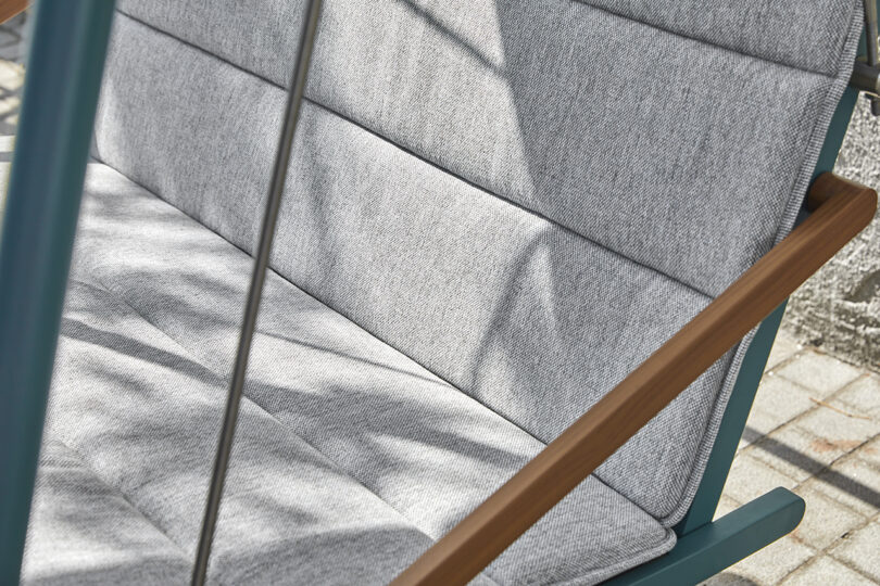 detail of steel framed covered outdoor swing with cushion
