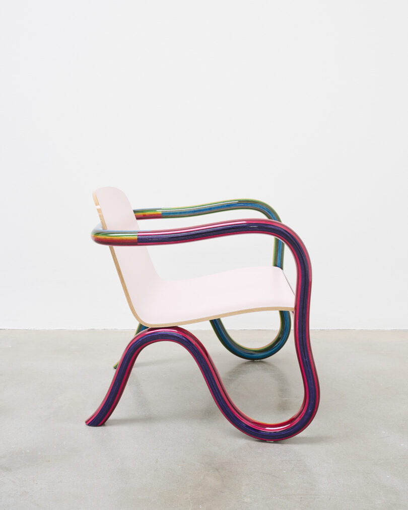 lounge chair with rainbow plywood frame and pale pink seat