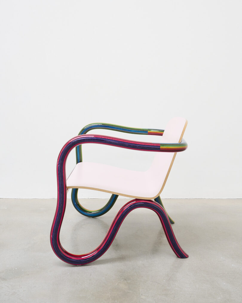 lounge chair with rainbow plywood frame and pale pink seat
