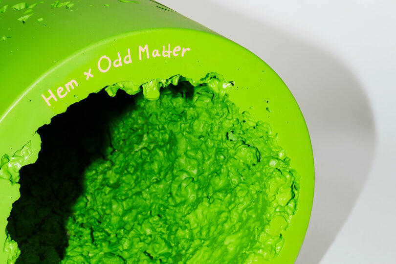 detail of neon green cylindrical stool on white background