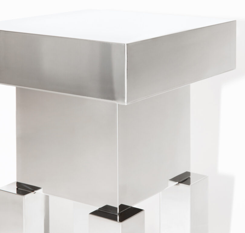 detail of squared off mirrored stool