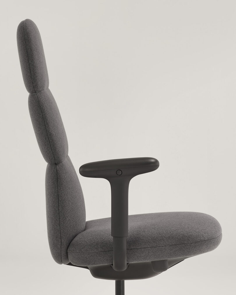 Side profile of Asari chair in grey showing chair arms.