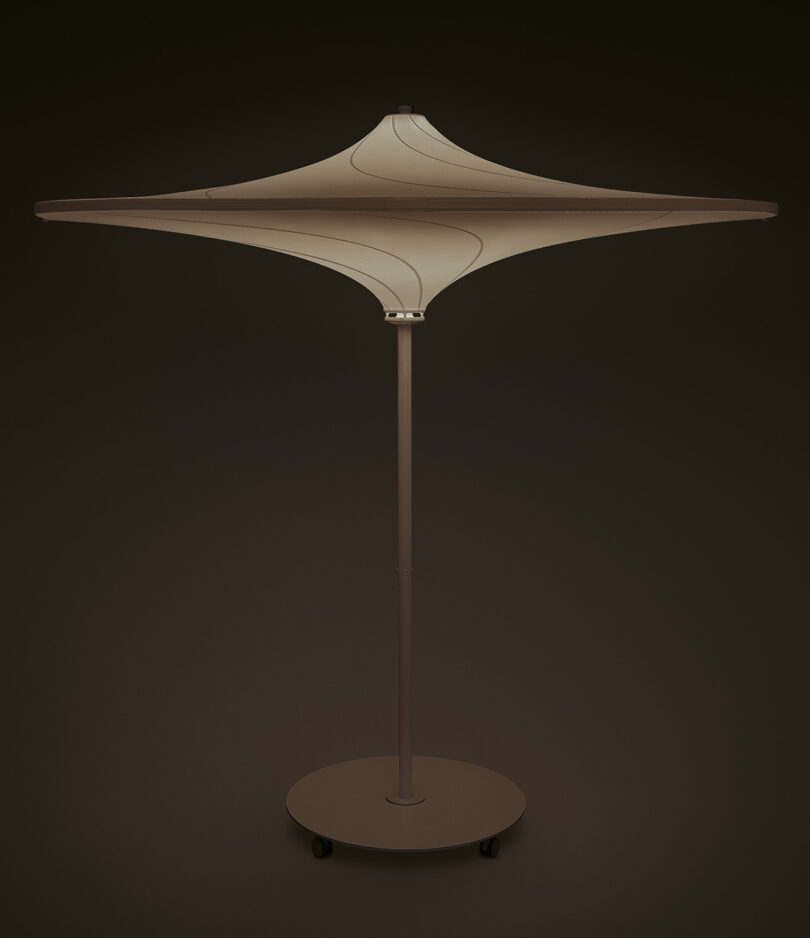 white outdoor umbrella with built-in light illuminated on black background