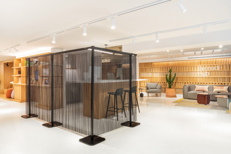 black freestanding chain space divider in the middle of an open office space