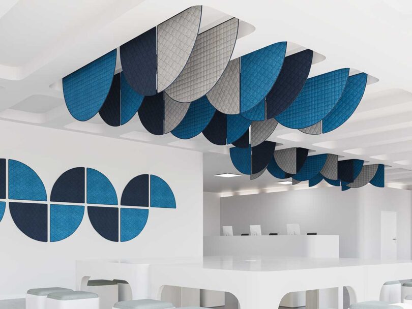 geometric acoustic panels in blues and greys hanging above tables