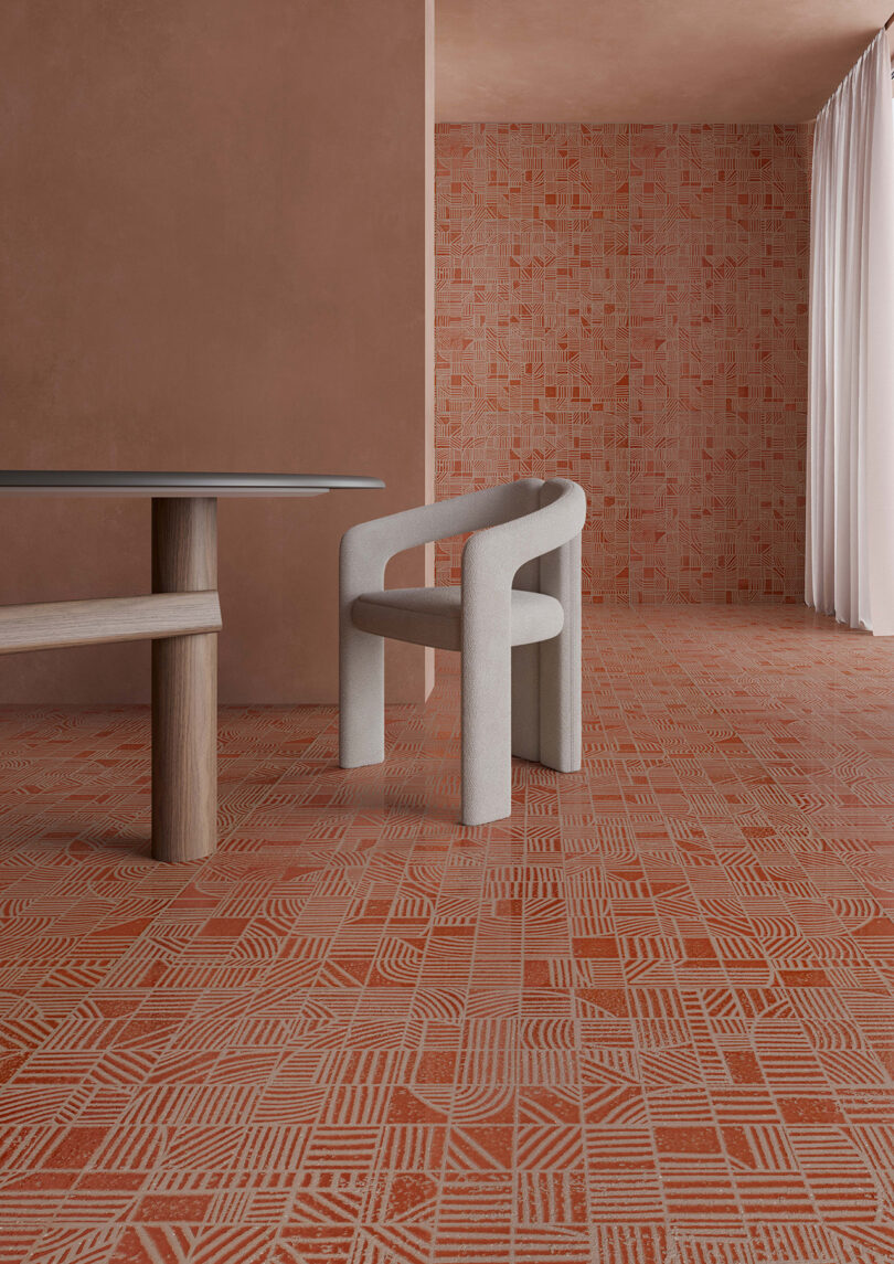 interior space styled entirely with terracotta tiled walls and flooring with dining table and chair