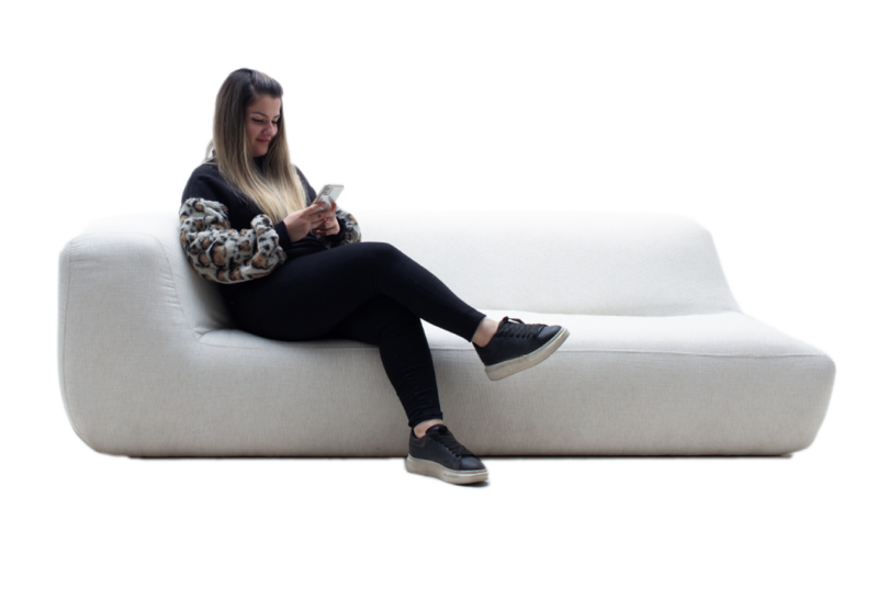 modern white chaise sofa with a person sitting on it