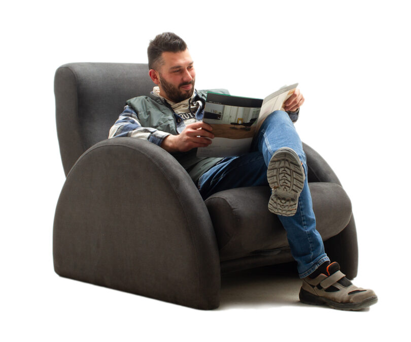 reclining black armchair with person reading seated