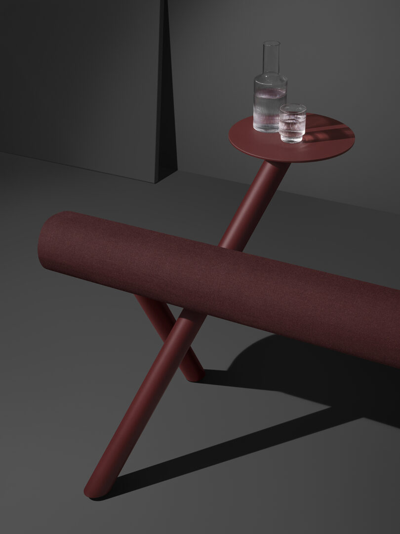 long dark maroon leaning bench with small attached round table