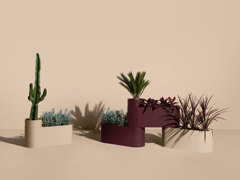 modular dark maroon and beige planters with greenery against a beige background