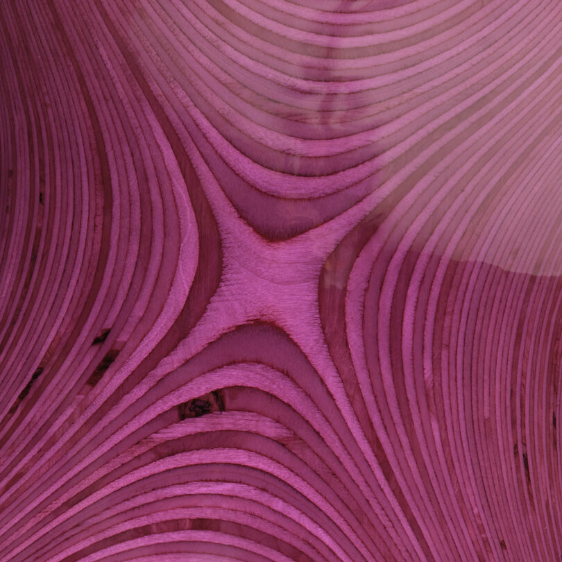 detail of glossy purple curvaceous stacked plywood table