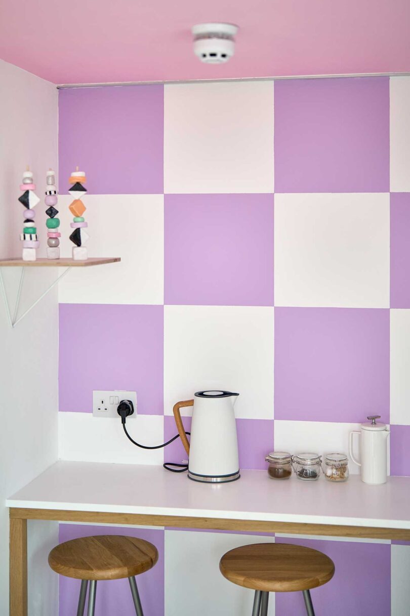 small kitchen interior with lavender and white checked walls