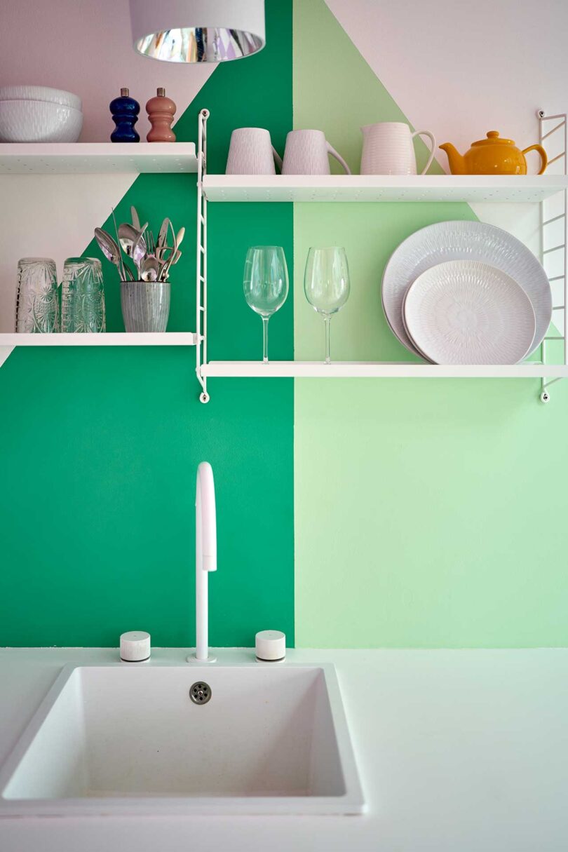 closeup of small kitchen interior wall with two tone green triangle