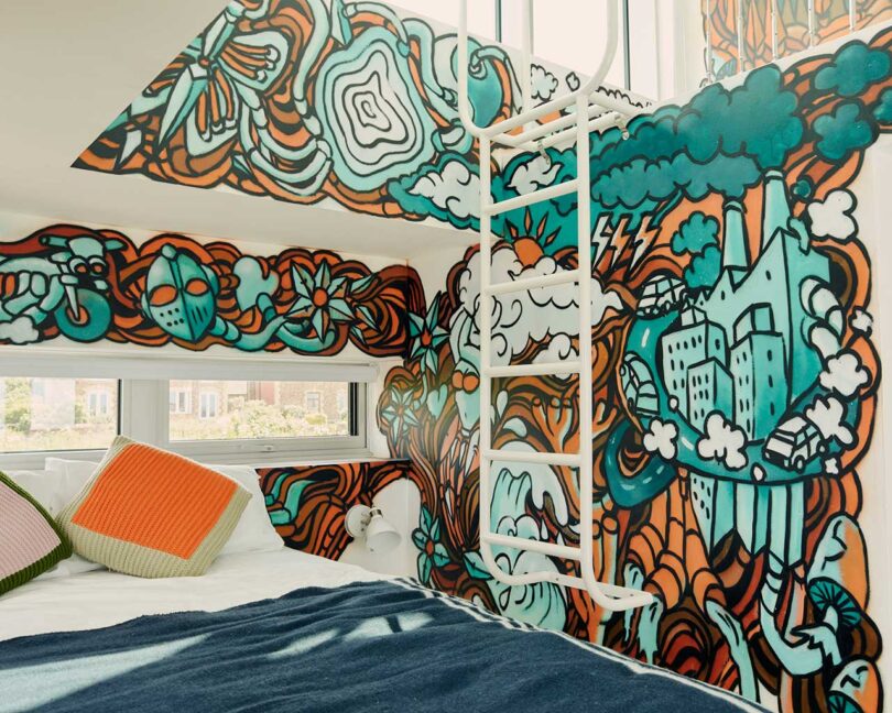 angled interior view of small bedroom with graffiti art on walls