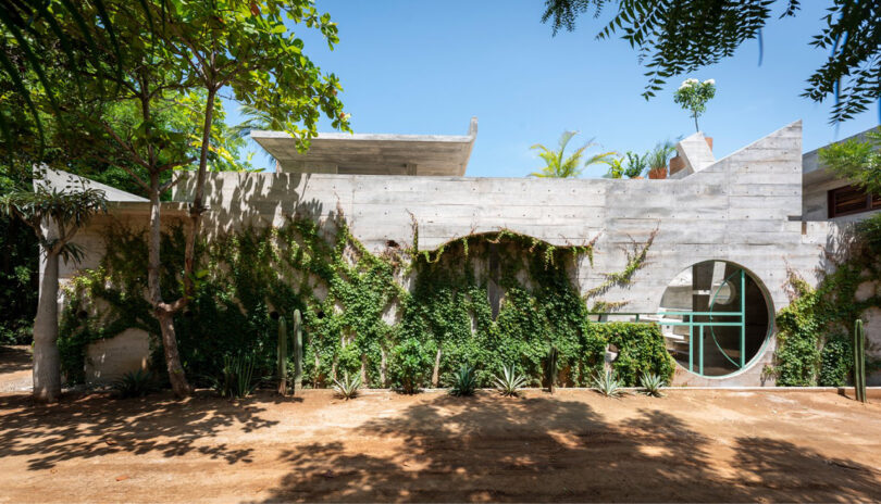 exterior view of hotel in Mexico with geometric concrete exterior and greenery all around