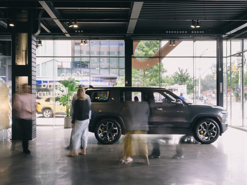 Interior of Rivian Spaces High Line, New York City with parked Rivian R1T and R1S parked inside.