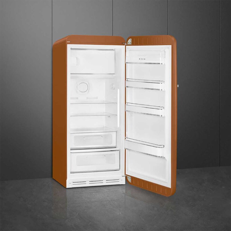 angled view of rust colored fridge opened to reveal white shelves
