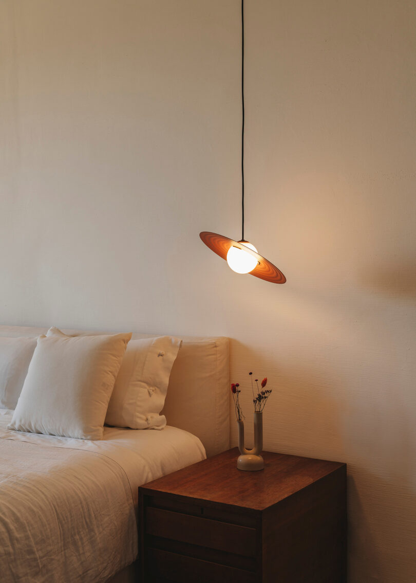 burnt orange saucer-shaped light pendant bedside