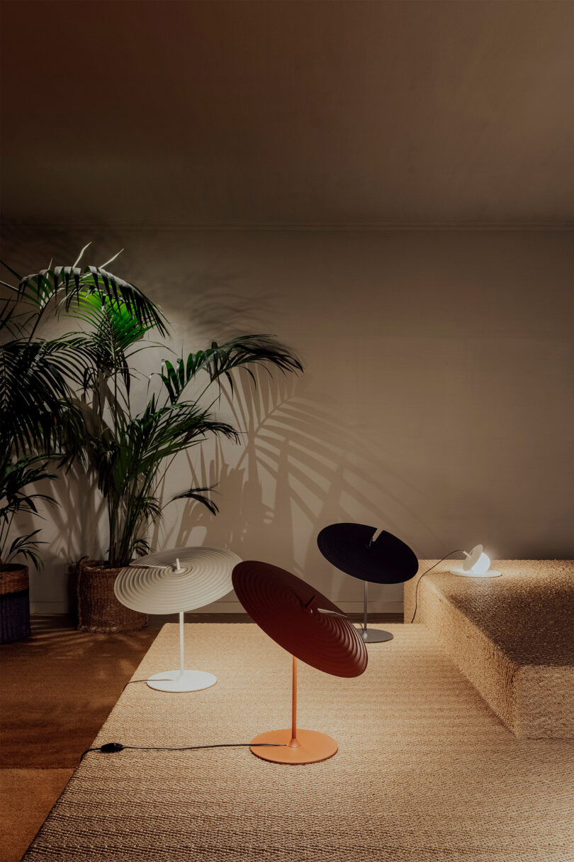 three table lamps with saucer-shaped shade in a styled living space
