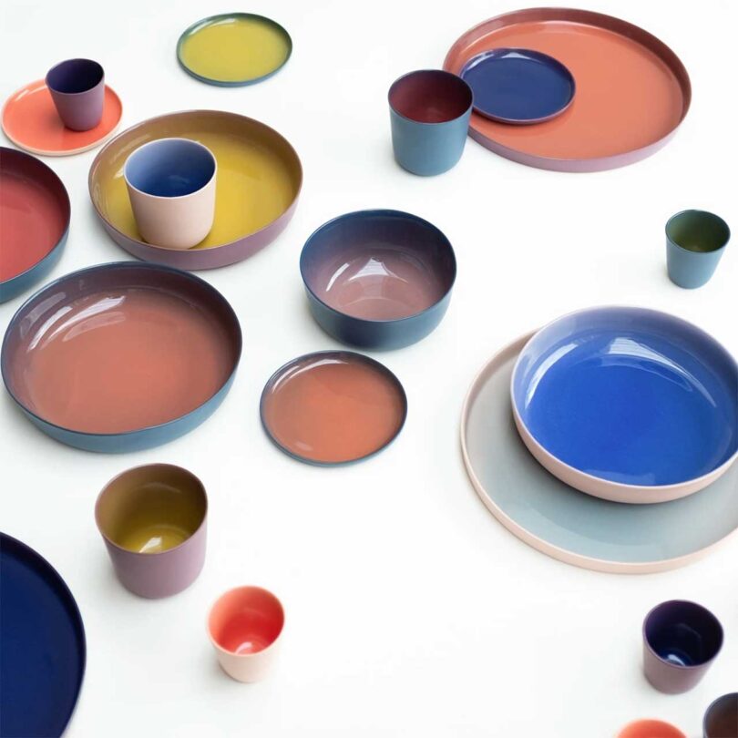 angled above view of array of ceramic tableware with gradient colors