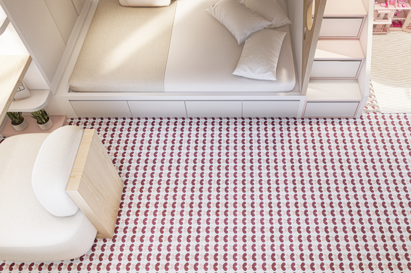 overhead view of a living space with white furniture featuring a pink and maroon tiled floor