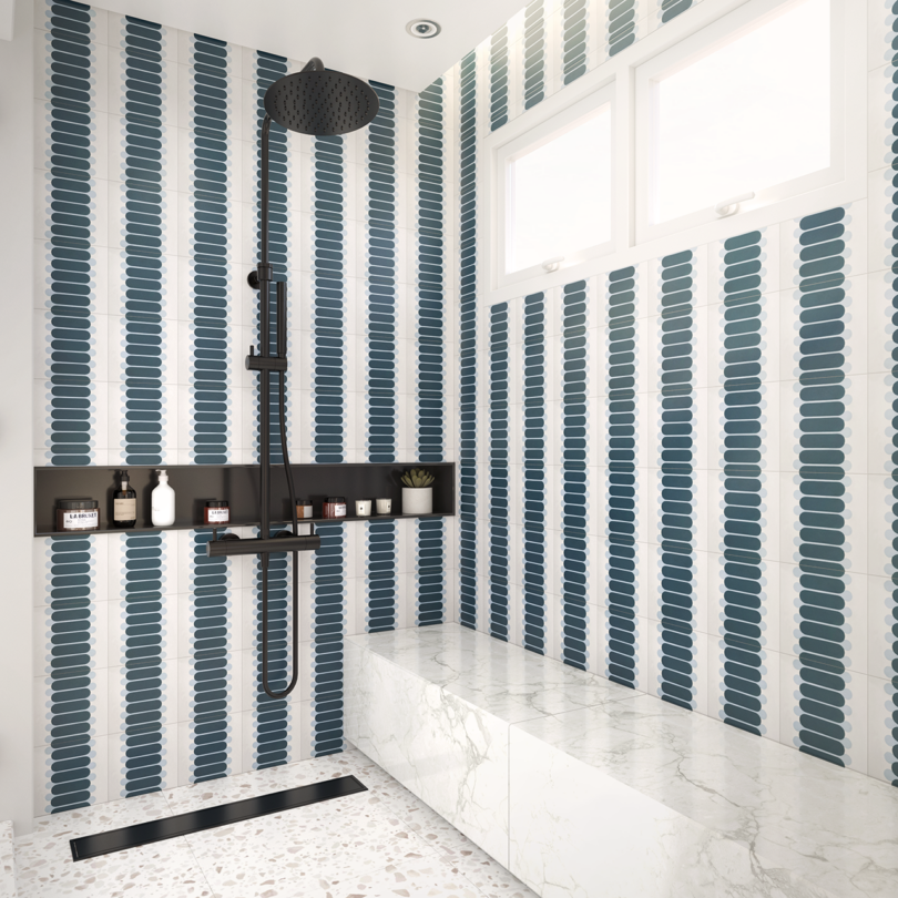 walk-in shower featuring navy and light blue patterned tiling on the walls