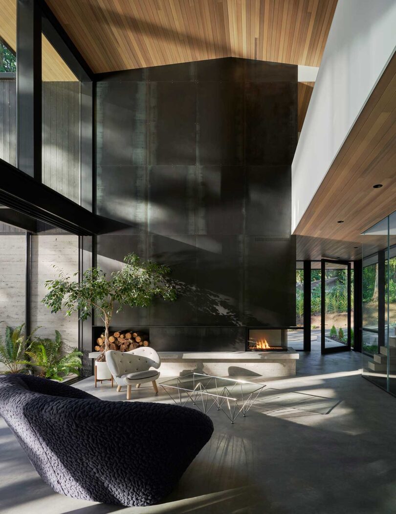 interior shot of modern living room with double height ceiling and wall of windows and modern furnishings