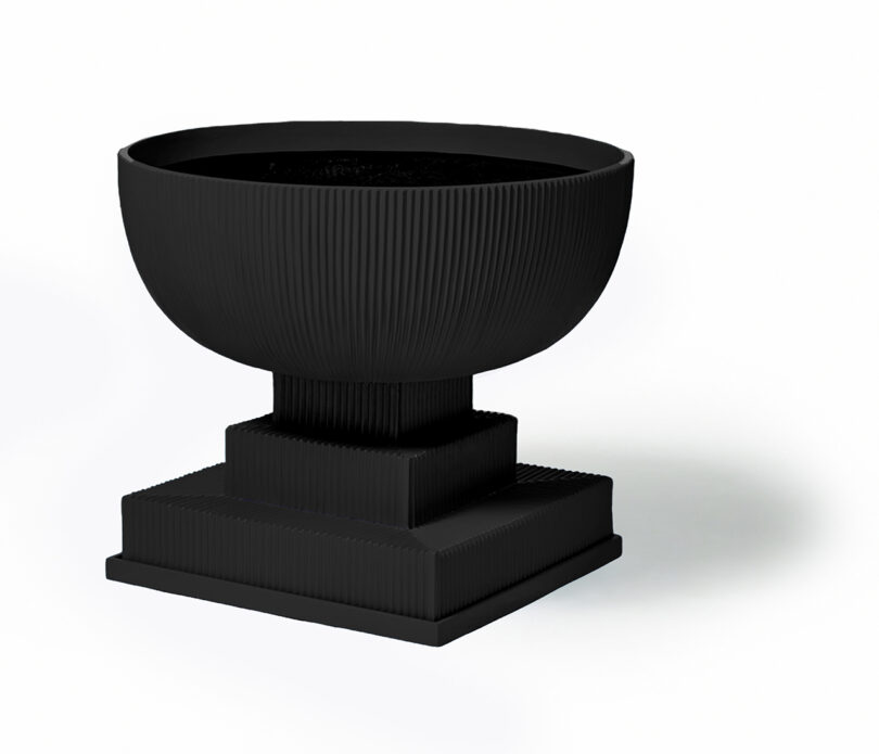 modern black fluted urn on white background