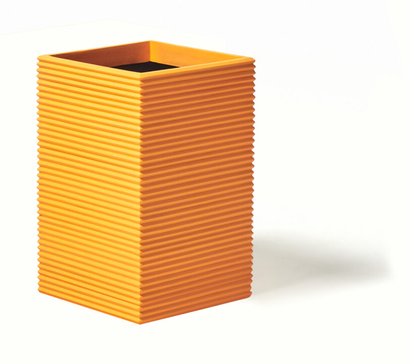 modern tall rectangular fluted orange planter on white background