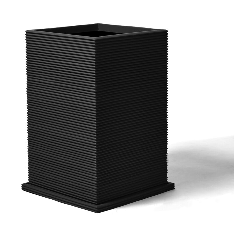 modern tall rectangular fluted black planter on white background