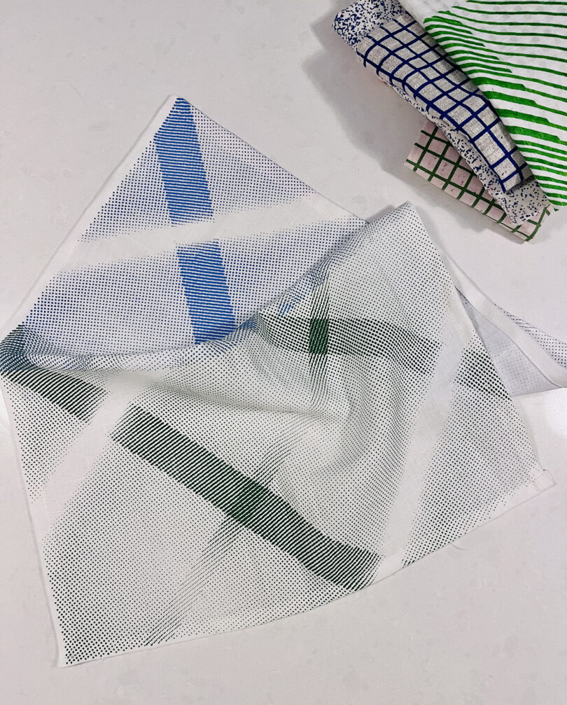 white fabric with green and bluea patterns