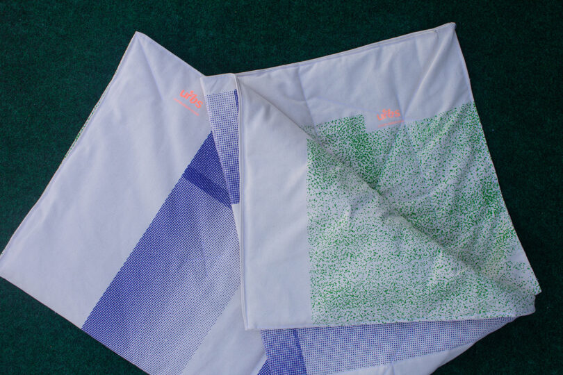 white fabric with green and blue abstract patterns