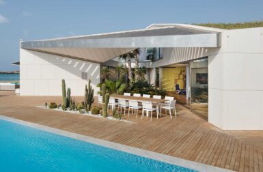 An Art Collector's Villa With an Angular Green Roof + Triangular Pool