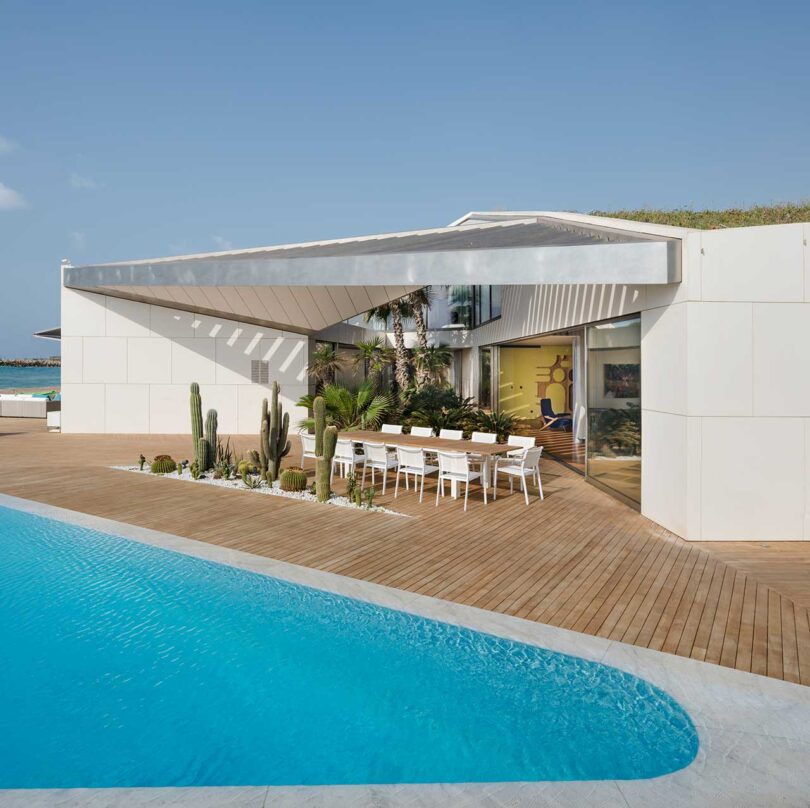 An Art Collector’s Villa With an Angular Green Roof + Triangular Pool