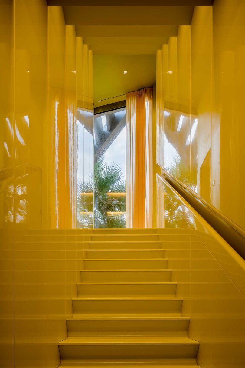 looking up glossy yellow staircase