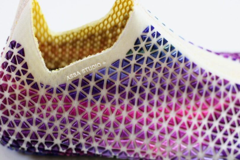 Detail of triangular color changing pieces attached to Evolve shoes fabric uppers.
