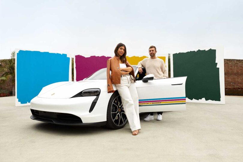 a man and woman leaning on a vintage white porsche car with four colored stripes going down side