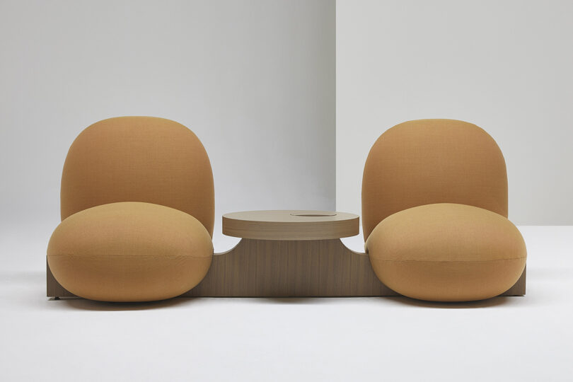 two bulbous overstuffed chairs with side table
