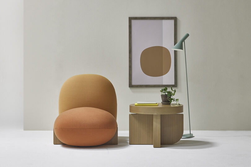 bulbous overstuffed chair and round side table in a styled space