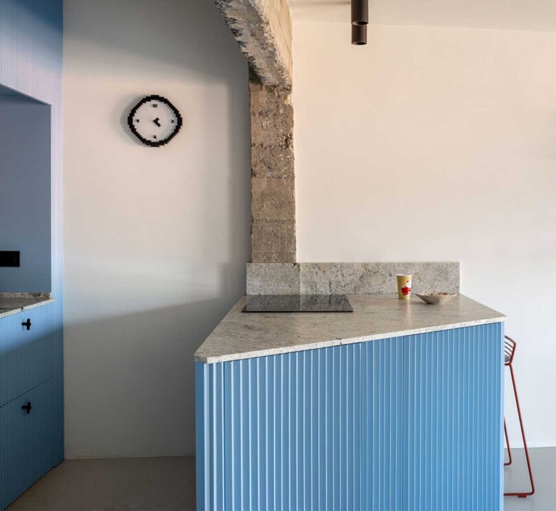 side view of modern light blue kitchen with concrete details