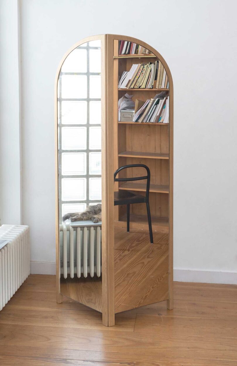 light wood arch-shaped bi-fold floor mirror in styled space