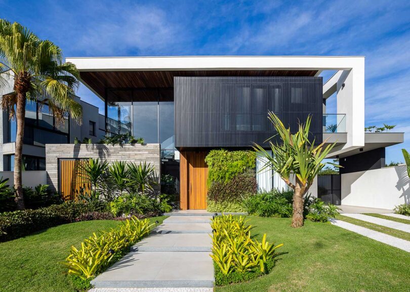 daytime exterior view of modern house with tropical plants