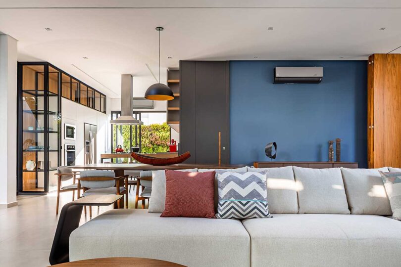 partial living room view in modern house looking into kitchen