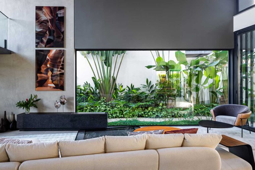 view of modern living room with massive opening to outside