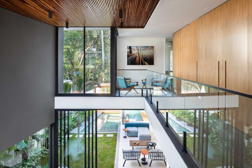 view from upper level looking down into open living space below in modern house